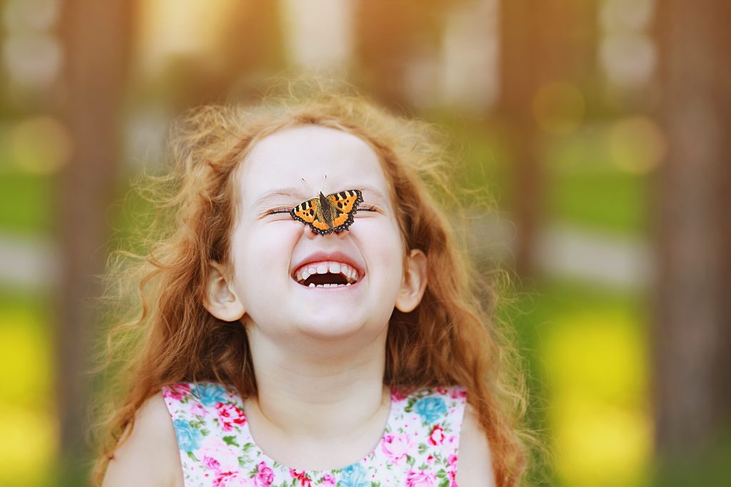 Girl with butterfly on her nose